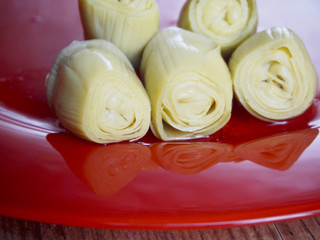 Hearts of artichokes in a red plate
