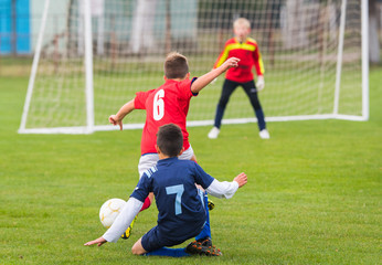 Obraz premium Boys kicking ball