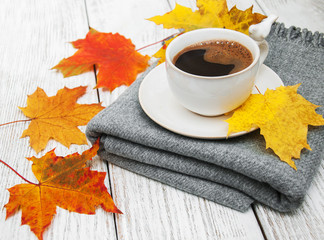 Cup of coffee and autumn leaves