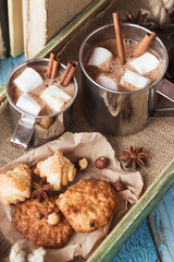 Metal mugs with cacao and marshmallows