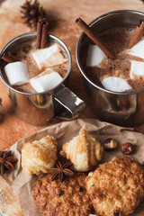 Metal mugs with cacao and marshmallows