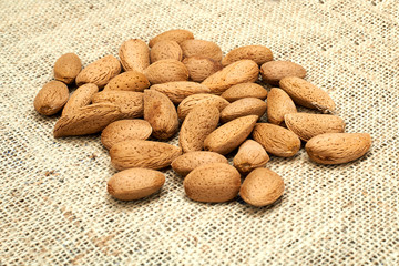 Almonds on a burlap background.