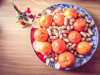 Christmas Candle And Food Decoration With Mandarins And Peanuts Festive Plate