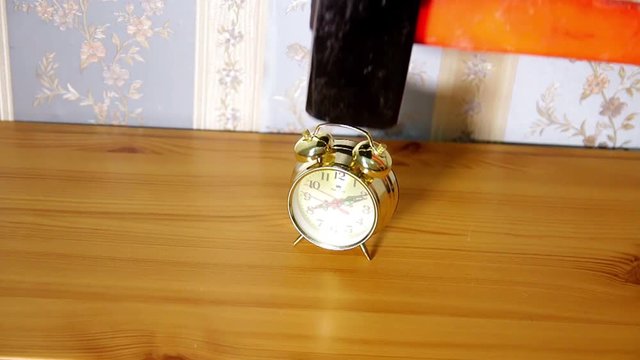 alarm clock destroyed with a hammer