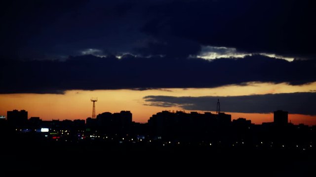 Timelapse of sunset over silhouette city skyline. 3840x2160