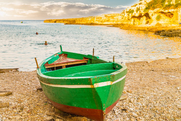 Green rowing boats on the beach