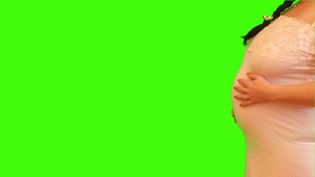 Pregnant woman stroke the belly - body profile position aside chroma key