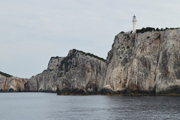 Fototapeta na wymiar Lighthouse on Lefkada cape - the most southern point of Lefkada Island, Greece
