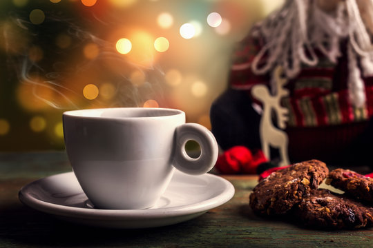 Fototapeta Christmas coffee on table with boheh lights in background