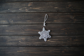 Fabric Christmas ornament hanging on wooden background