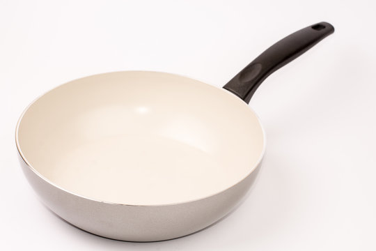 Empty frying ceramic pan on a white background