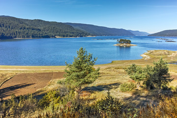 Fototapeta na wymiar Autumn Landscape with island in the water of Dospat Reservoir, Smolyan Region, Bulgaria