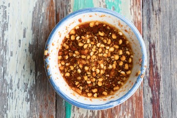 red hot chilli sauce over wooden background