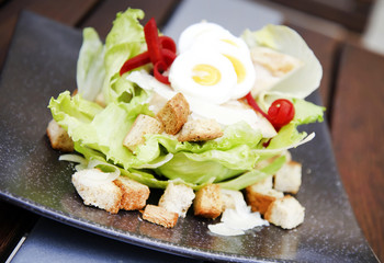 Cesar salad with egg slices and toast cubes on a plate