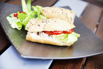 Sandwich with ham, cheese, tomato slice and lettuce leaf