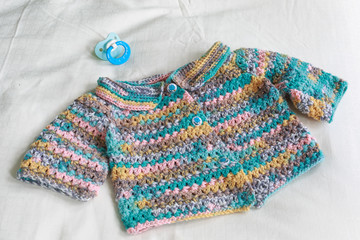Hand crocheted sweater for a baby.