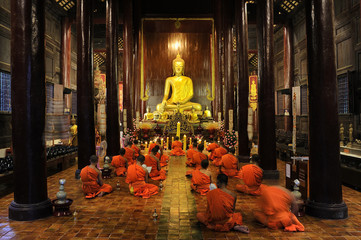 Buddhist monks pray and meditate every day evening at Wat Phan Tao in CHIANG MAI THAILAND.