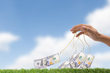 fishing hook and One hundred dollar bill isolated on sky cloud