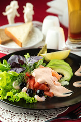 Delicious salad with shrimp, avocado, tomatoes, black olives and rosette sauce