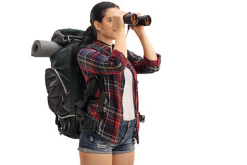 Female hiker looking through binoculars