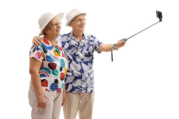 Mature tourists taking a selfie with a stick