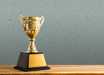 champion golden trophy on wood table with copy space, copy space