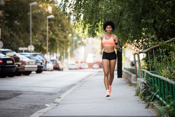 Fototapeta na wymiar Healthy woman runner listening to music.