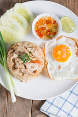 Pork fried rice and fried egg with vegetable.
