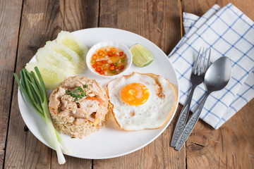 Pork fried rice and fried egg with vegetable.