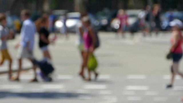 Side view blurred pedestrians crossing a street in the city of Barcelona in summer.Slow 
Motion