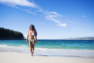 young woman walking in the beach