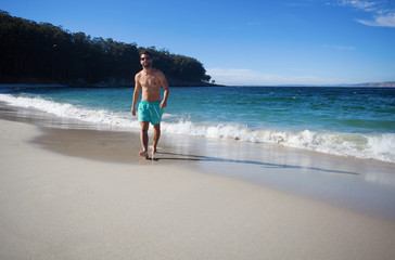 Fototapeta na wymiar young man walking in the beach
