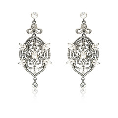 Fototapeta na wymiar Pair of silver diamond earrings isolated on white