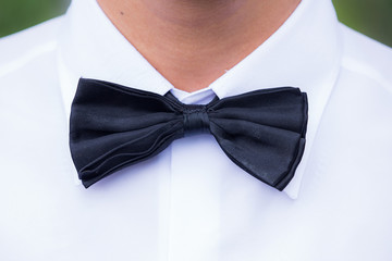 Black silk bow tie and white cotton dress shirt