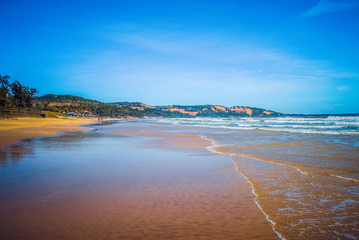 Mui Ne beach, Vietnam. Kitesurfing in the open ocean. Vietnam, Mui Ne beach. Wind and waves. Beach on a clear day.