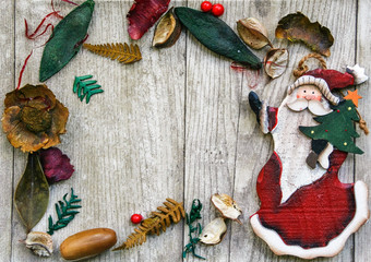 frame of pot pourry and wooden santa klaus on wooden background 
