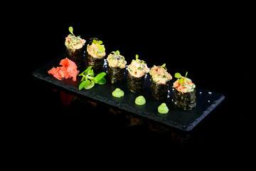 spicy sushi on black backgound with reflection