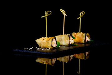 Eggplant roll stuffed on black background