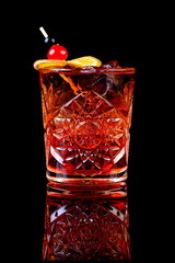 alcohol coctail on black background with reflection