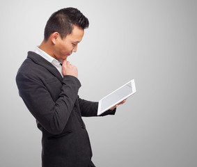 portrait of an asian man using a tablet