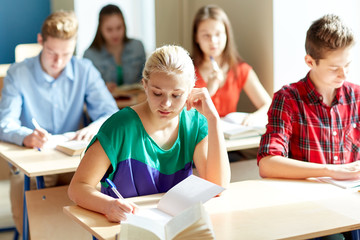 Fototapeta premium group of students with books writing school test