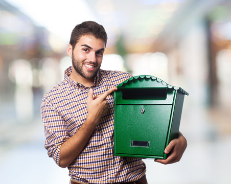 A handsome young man holding a malbox