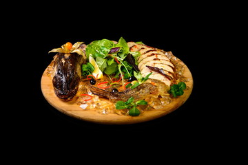 stuffed pike with greens on a black background
