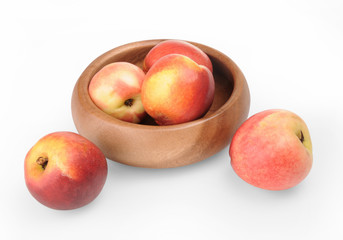 Nectarines in wooden bowl , isolated on a white background 