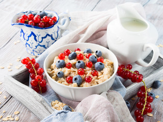 Porridge with blueberries in a wooden tray