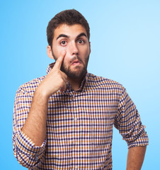 portrait of a young man pointing his eye