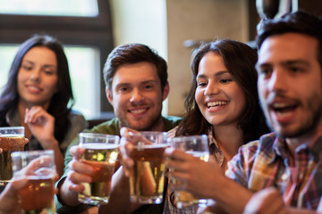 happy friends drinking beer at bar or pub