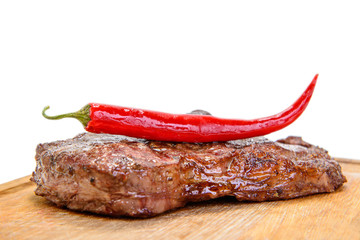 steak with pepper on wood plate