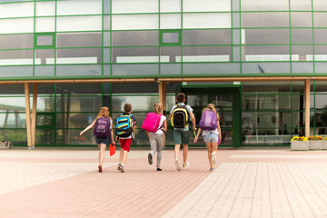 group of happy elementary school students running