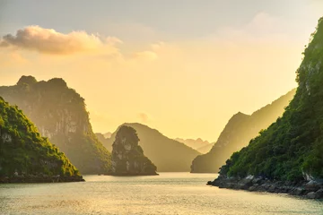Foto auf Acrylglas Dreamy sunset among the rocks of Halong Bay, Vietnam © nevskyphoto